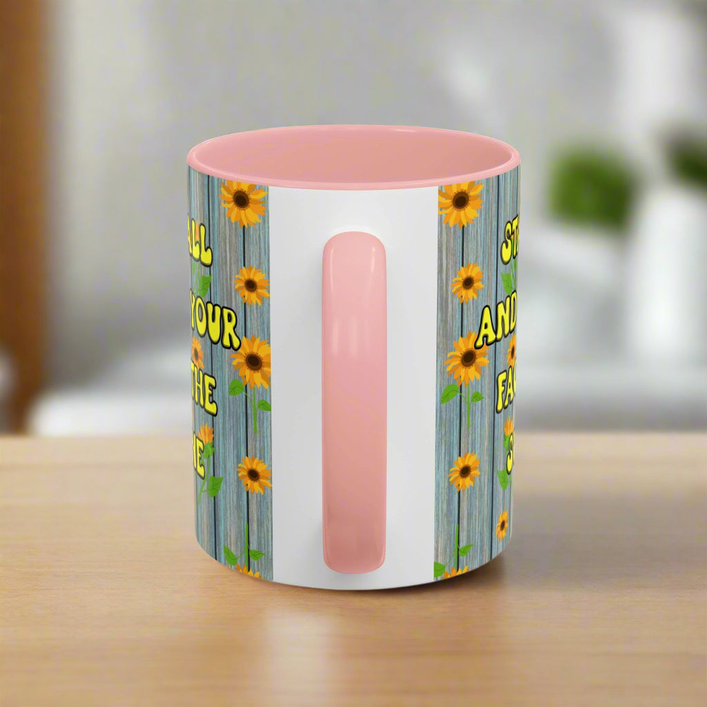 ceramic mug with sunflower background quote "Stand tall and keep your face to the sunshine" pink interior pink handle
