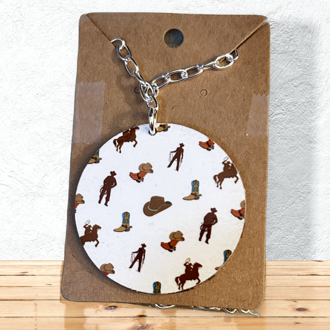 2" round cowboy, boots and hats pendent on 18" silver chain on shellf