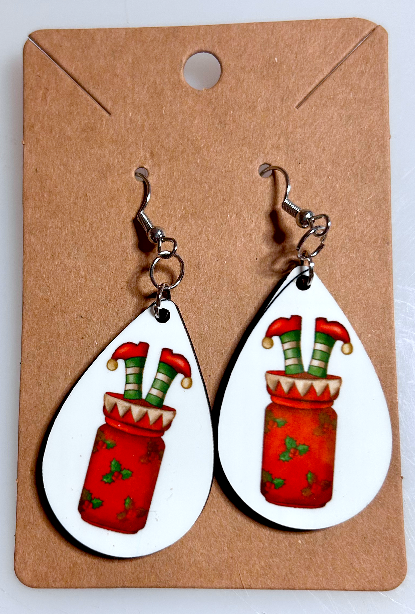 elf in jar of drink teardrop earrings on backing card